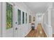Bright foyer with hardwood floors, decorative glass in the front door, and a hallway at 11100 Honeycutt Rd, Raleigh, NC 27614