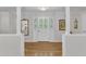 Bright foyer featuring hardwood floors, white trim, and decorative glass door with sidelights at 11100 Honeycutt Rd, Raleigh, NC 27614
