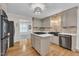 Modern kitchen with stainless steel appliances, island cooktop, and stylish light fixture at 11100 Honeycutt Rd, Raleigh, NC 27614