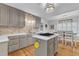 Modern kitchen with island cooktop, stainless steel appliances, and eat-in breakfast area at 11100 Honeycutt Rd, Raleigh, NC 27614