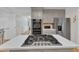 Open kitchen layout featuring a center island with cooktop and stainless steel appliances at 11100 Honeycutt Rd, Raleigh, NC 27614