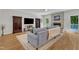 Spacious living room featuring hardwood floors, a fireplace, and backyard views at 11100 Honeycutt Rd, Raleigh, NC 27614
