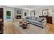 Comfortable living room features a brick fireplace, plush sofa, and natural lighting at 11100 Honeycutt Rd, Raleigh, NC 27614