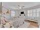 Bright main bedroom with a ceiling fan, natural light, and hardwood flooring at 11100 Honeycutt Rd, Raleigh, NC 27614
