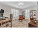 Bright office space featuring a stylish accent chair, custom shutters, and a decorative rug at 11100 Honeycutt Rd, Raleigh, NC 27614