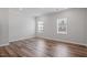 Spacious bedroom features hardwood floors and ample natural light from dual windows at 1114 Crossvine Trl, Durham, NC 27703