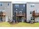Townhome exterior with small decks overlooking a private backyard space and lawn at 1114 Crossvine Trl, Durham, NC 27703