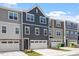 Row of elegant townhomes featuring coordinated design and individual garages at 1114 Crossvine Trl, Durham, NC 27703