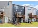 Townhome exterior showcasing decks, modern siding, and well-kept backyard space at 1114 Crossvine Trl, Durham, NC 27703