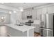 Stylish kitchen boasts modern appliances, an island with quartz countertop, and ample cabinet space at 1114 Crossvine Trl, Durham, NC 27703