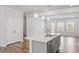 Open concept kitchen with large island, stainless appliances, quartz counters and hardwood floors at 1114 Crossvine Trl, Durham, NC 27703