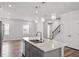 Kitchen island boasts stainless dishwasher and sink, a quartz countertop and stylish pendant lighting at 1114 Crossvine Trl, Durham, NC 27703