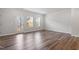 Open living room with hardwood floors, large windows and a glass door at 1114 Crossvine Trl, Durham, NC 27703
