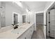 Modern bathroom featuring double vanity, quartz countertop, tile flooring, and a well-organized walk-in closet at 112 Lager Ln, Garner, NC 27529