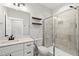 Bathroom with stone countertop, a glass-enclosed shower, and modern fixtures at 112 Lager Ln, Garner, NC 27529