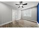 Bright bedroom featuring wood floors, a ceiling fan, and a large window at 112 Lager Ln, Garner, NC 27529