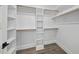 Bright, organized walk-in closet with wooden racks and shelving, complemented by stylish laminate flooring at 112 Lager Ln, Garner, NC 27529
