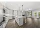 Bright open kitchen featuring an island, fireplace, and stainless steel appliances at 112 Lager Ln, Garner, NC 27529