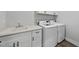 Convenient laundry room with modern washer and dryer, a countertop, and cabinets at 112 Lager Ln, Garner, NC 27529