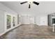 Spacious living room featuring a chandelier, ceiling fan, and windows to the backyard at 112 Lager Ln, Garner, NC 27529
