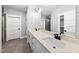 Main bathroom featuring a double sink vanity, large mirror, and glass shower at 112 Lager Ln, Garner, NC 27529