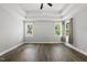 Spacious main bedroom featuring a tray ceiling, ceiling fan, and windows at 112 Lager Ln, Garner, NC 27529