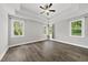 Spacious main bedroom featuring a tray ceiling, ceiling fan, and windows at 112 Lager Ln, Garner, NC 27529