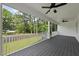 Covered porch with ceiling fan and railings provides a relaxing outdoor space to enjoy the serene, green surroundings at 112 Lager Ln, Garner, NC 27529