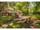 Back yard and garage with seating and grill near green trees at 1120 E Oak Dr, Durham, NC 27712
