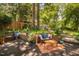 Back yard patio area with seating, a small table, and various potted plants at 1120 E Oak Dr, Durham, NC 27712