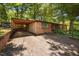 Home exterior with a brick facade, covered carport, and mature trees at 1120 E Oak Dr, Durham, NC 27712