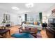 Bright living room with hardwood floors, large windows, and stylish decor, offering a comfortable space at 1120 E Oak Dr, Durham, NC 27712