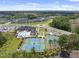 Aerial view of a clubhouse, pool, and tennis courts in a well-planned community at 1125 Surveyor Dr, Durham, NC 27703