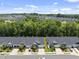 An aerial view of a neighborhood with townhomes backing up to a lush forest at 1125 Surveyor Dr, Durham, NC 27703