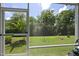 Lush backyard viewed through a screened door, showcasing a well-maintained lawn at 1125 Surveyor Dr, Durham, NC 27703