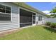 Exterior view of house from a grassy backyard with a screened porch at 1125 Surveyor Dr, Durham, NC 27703
