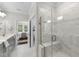 Modern bathroom with marble-tiled shower, glass enclosure, and vanity with double sinks at 1125 Surveyor Dr, Durham, NC 27703