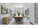 Elegant dining area with hardwood floors, a stylish buffet cabinet, and a sliding door to the backyard at 1125 Surveyor Dr, Durham, NC 27703
