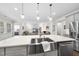 Kitchen island with stainless steel sink and faucet, plenty of counter space, and modern pendant lighting at 1125 Surveyor Dr, Durham, NC 27703