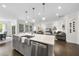 Kitchen island with stainless steel sink and dishwasher in a bright space open to the living room at 1125 Surveyor Dr, Durham, NC 27703