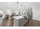 Open concept kitchen with stainless steel appliances and views of the adjacent living room at 1125 Surveyor Dr, Durham, NC 27703