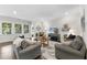 Cozy living room showcasing hardwood floors, a large window, and comfortable seating at 1125 Surveyor Dr, Durham, NC 27703