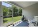 Relaxing screened porch with rocking chair overlooking a spacious backyard at 1125 Surveyor Dr, Durham, NC 27703