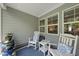 Cozy screened porch with two rocking chairs and a small table at 1125 Surveyor Dr, Durham, NC 27703
