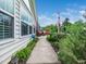 Backyard patio area, featuring a comfortable seating area, walkway, and beautiful flower garden at 1167 Blue Bird Ln, Wake Forest, NC 27587