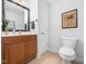Updated half-bath with stylish vanity, framed mirror, and charming decorative accents at 1167 Blue Bird Ln, Wake Forest, NC 27587