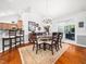 Elegant dining room with a chandelier, adjacent to the kitchen, and featuring a doorway to an office at 1167 Blue Bird Ln, Wake Forest, NC 27587
