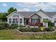 Inviting single-Gathering home featuring a cozy front patio adorned with comfortable outdoor seating and charming plants at 1167 Blue Bird Ln, Wake Forest, NC 27587