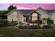 Charming home exterior with stone accents, landscaped yard, and cozy patio seating at 1167 Blue Bird Ln, Wake Forest, NC 27587