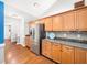 Well-lit kitchen with stainless steel refrigerator and ample counter space with granite countertops at 1167 Blue Bird Ln, Wake Forest, NC 27587